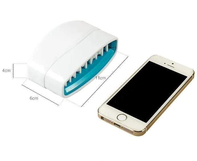 Coloured kitchen brush with knife and fork design and a white suction cup on its handle.