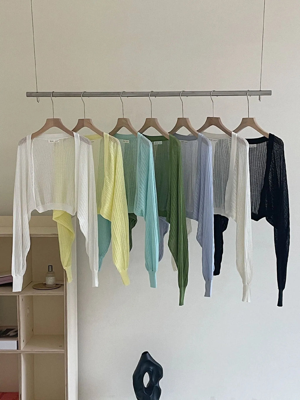 Women's apricot coloured blouse with long, loose lantern sleeves and hollow-out fabric detail.