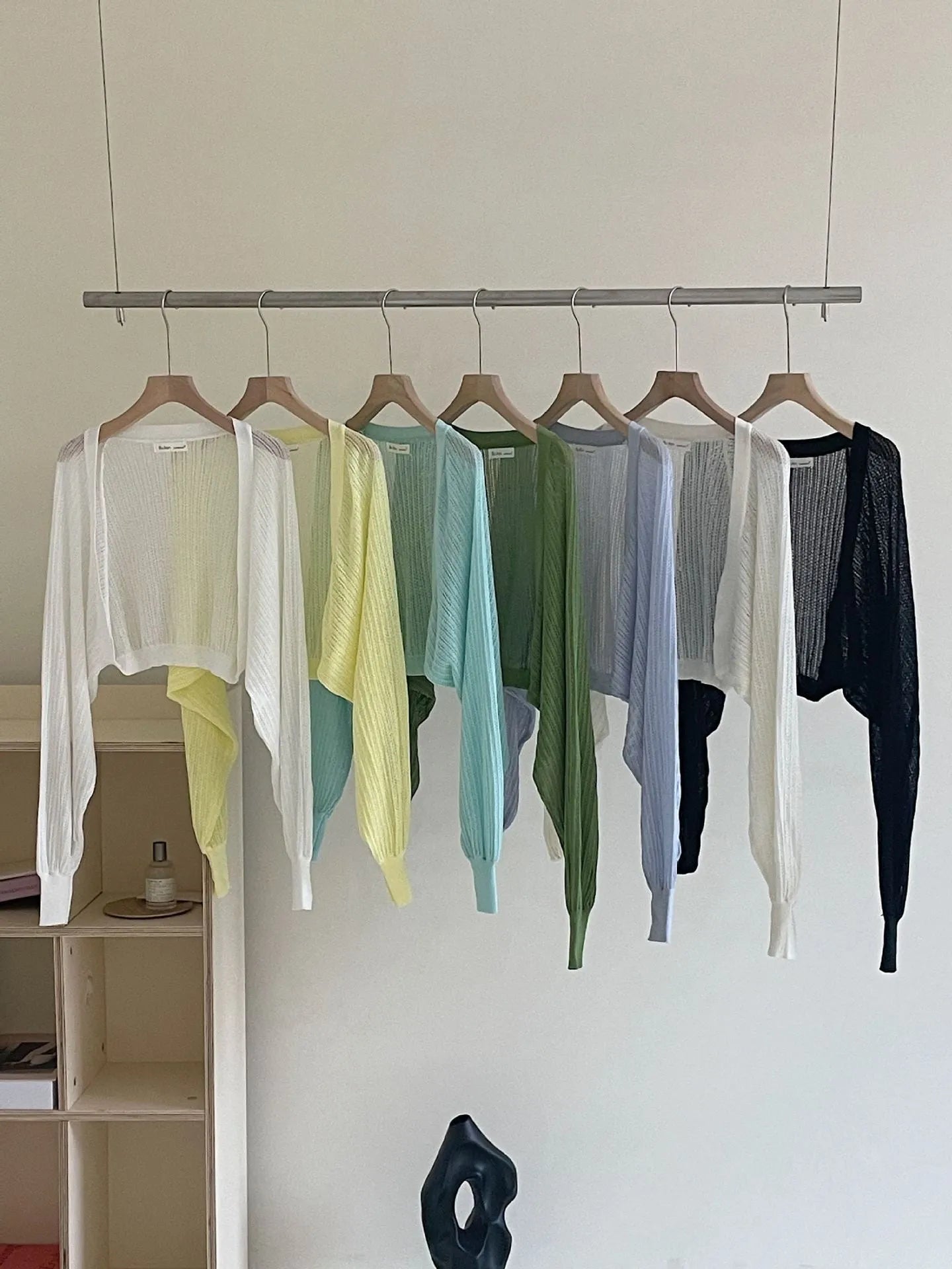 Women's apricot coloured blouse with long, loose lantern sleeves and hollow-out fabric detail.