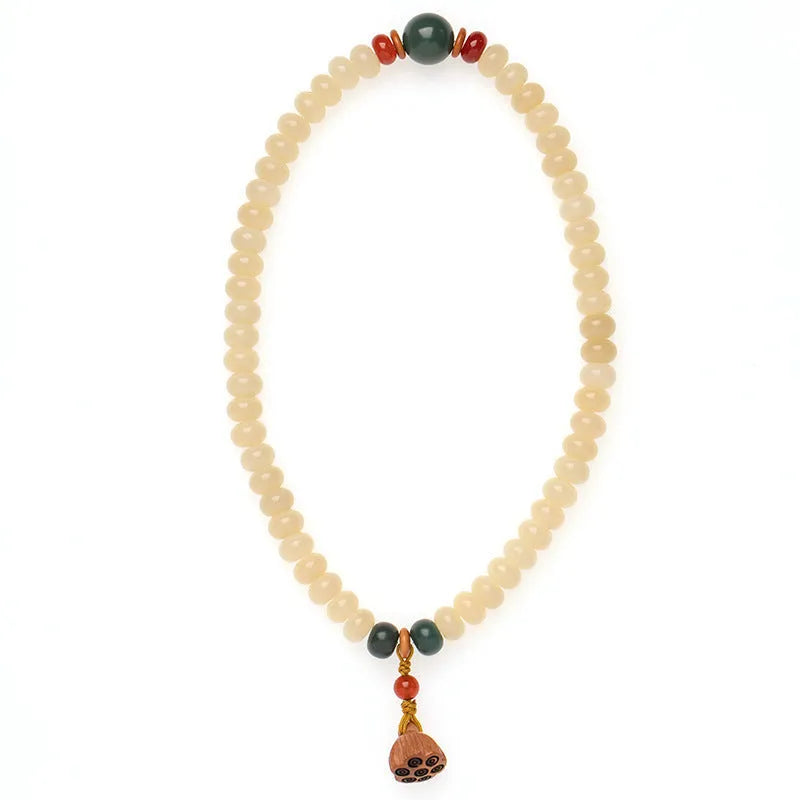 Cream topaz wooden bodhi root bracelet with 6x9mm flat round beads on wrist