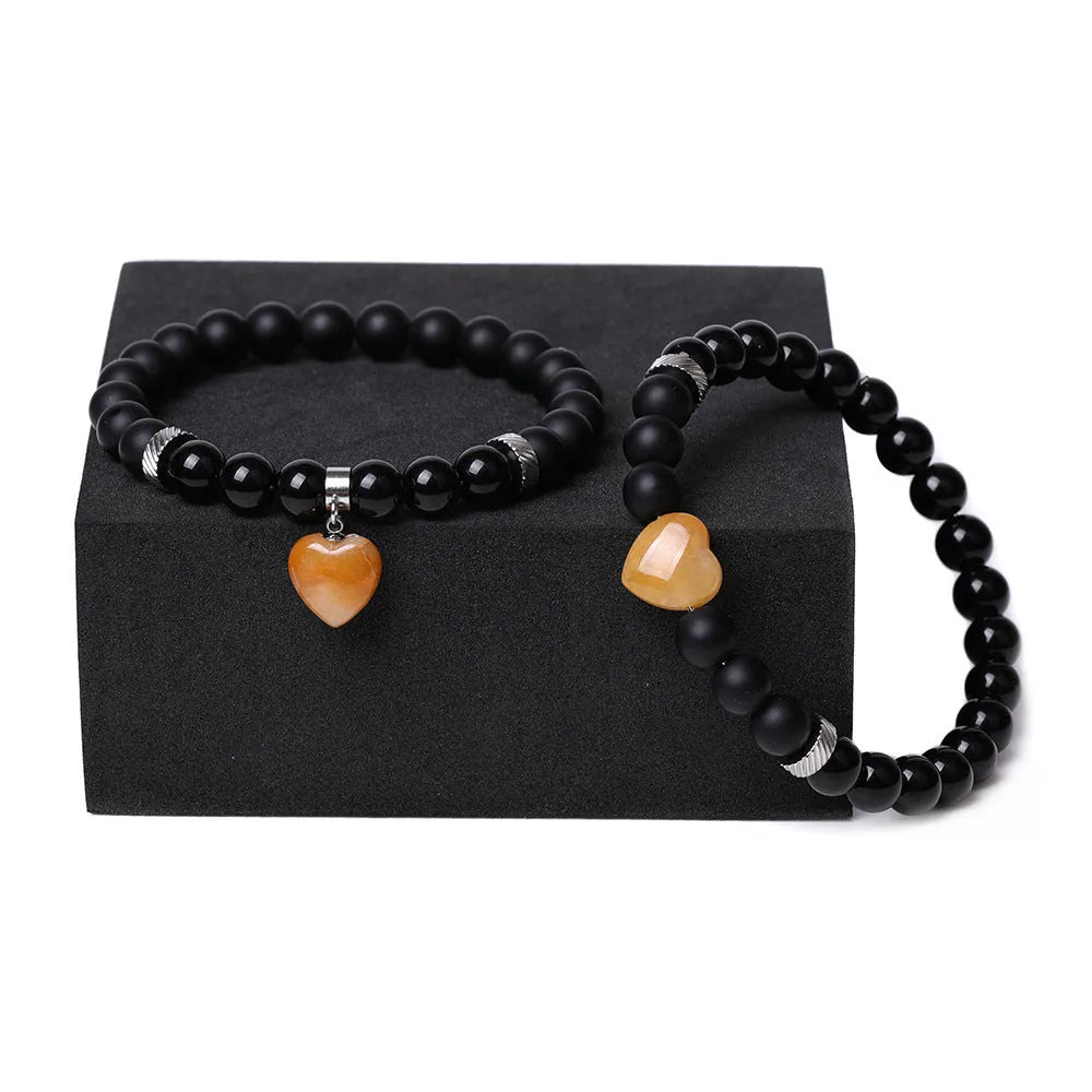 Matching natural stone couple bracelets with polished gemstone heart pendants