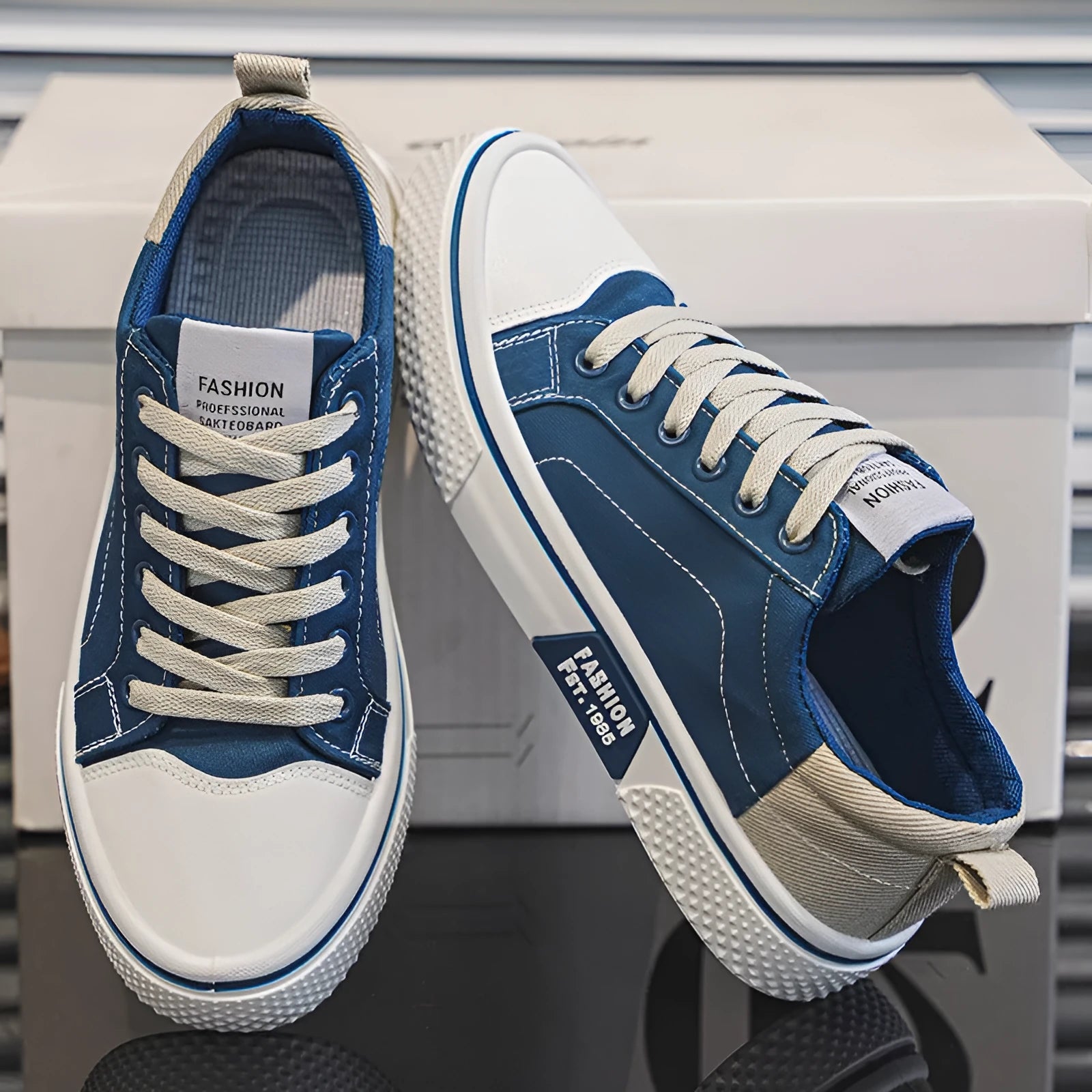 Men's low-top blue canvas shoes with round toe and white stitching on a soft PVC sole.