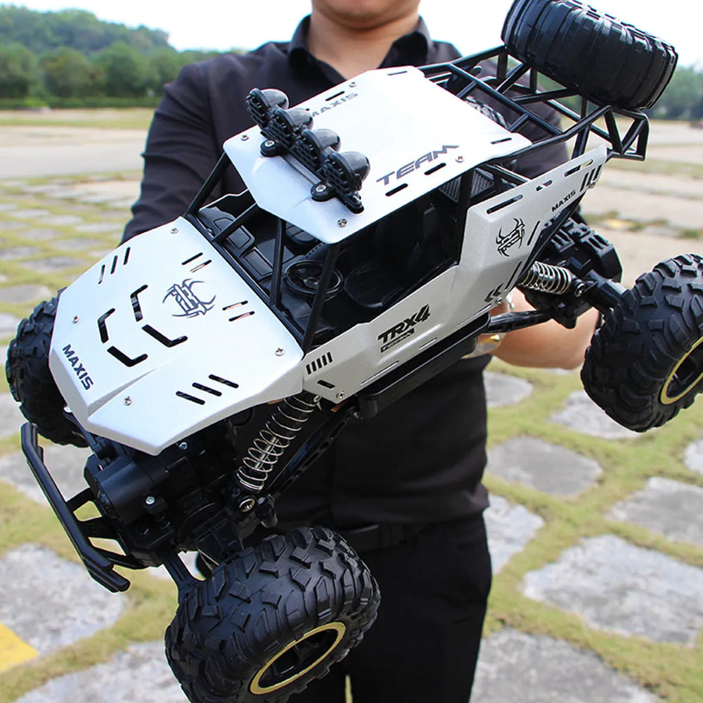 Black or silver remote control climbing car with 2.4G wireless remote on rough terrain