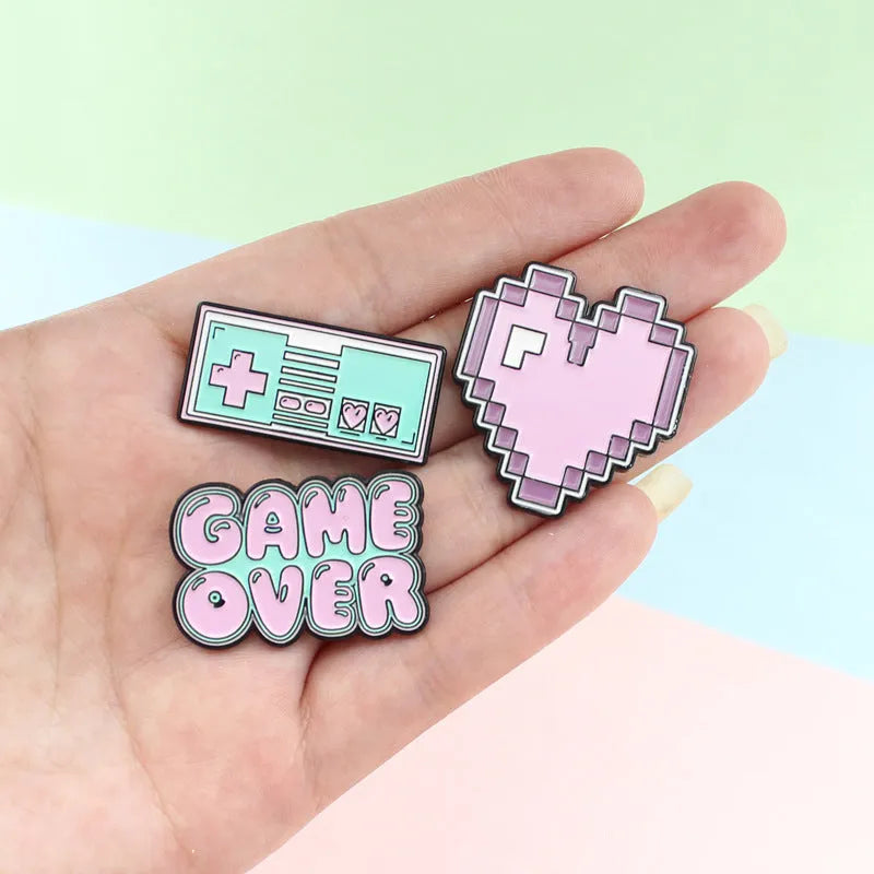 Three-dimensional alloy game console badge in metallic finish with mounting points