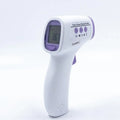 White digital thermometer displaying temperature reading on LCD screen