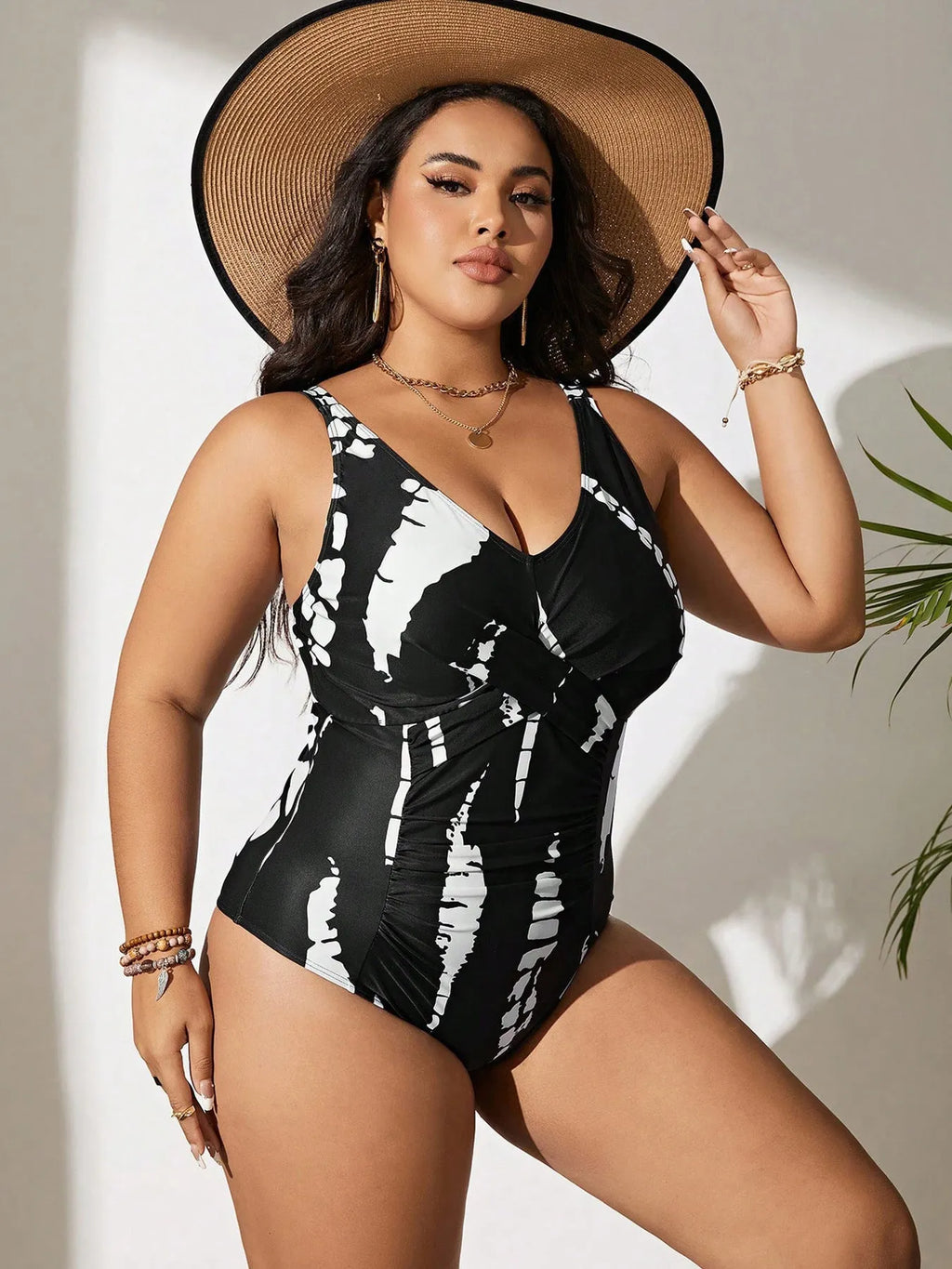 Black plus size one-piece swimsuit on a hanger, showing sleeveless conservative design.