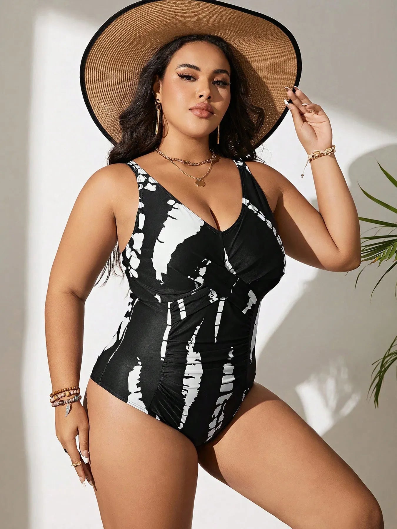 Black plus size one-piece swimsuit on a hanger, showing sleeveless conservative design.
