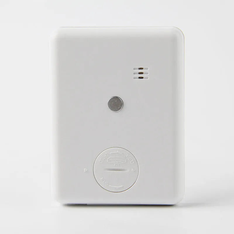Black and white kitchen timer with magnetic back showing dial interface for 60-minute timing
