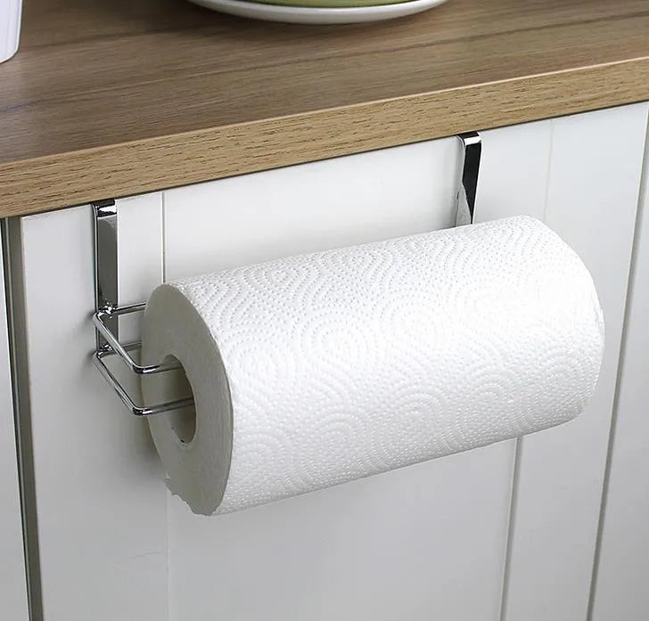 Silver stainless steel cabinet door back hanging paper towel rack on a kitchen cabinet.
