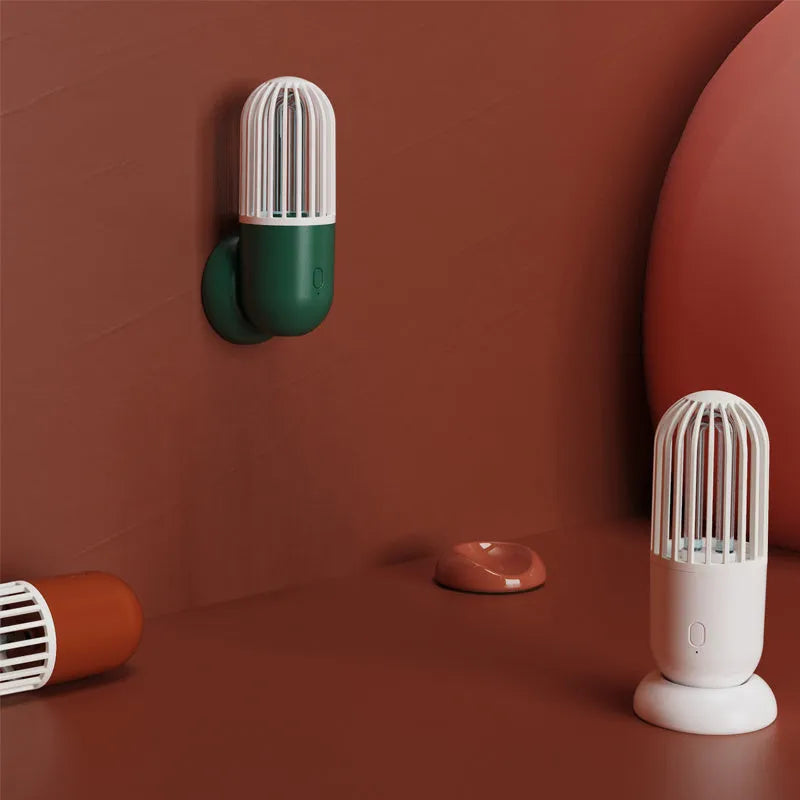 Compact portable UVC disinfection lamp in capsule design showing black, brown, green, and white colour options.