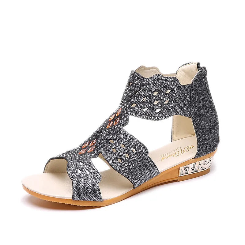 Women's beige open toe sandals with rhinestone detail and a back zipper on a flat rubber sole.