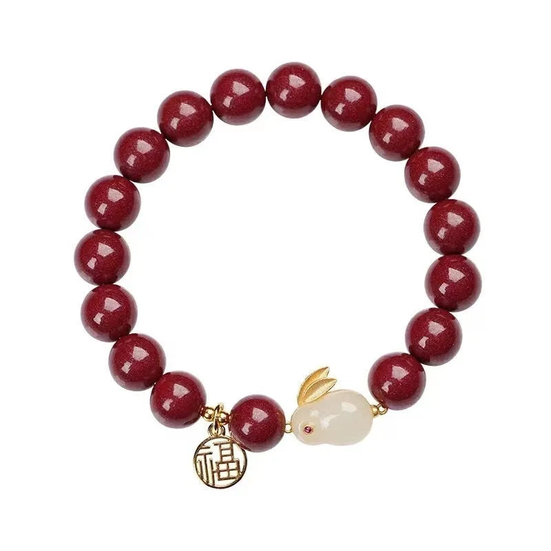 Cinnabar hare bracelet with purple gold sand beads on a wrist, showing retro jewellery style.