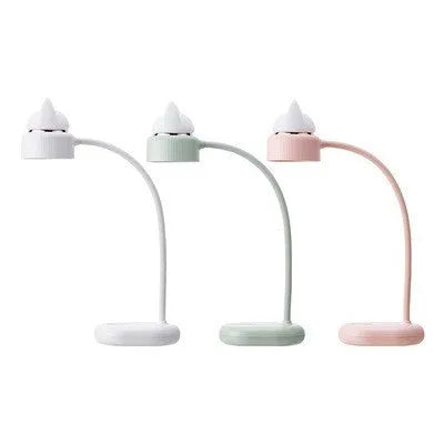 Green LED desk lamp with clip base and touch controls on a wooden desk surface