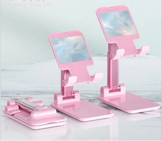 Black desk mobile phone holder made of silicone and ABS on a wooden desk.