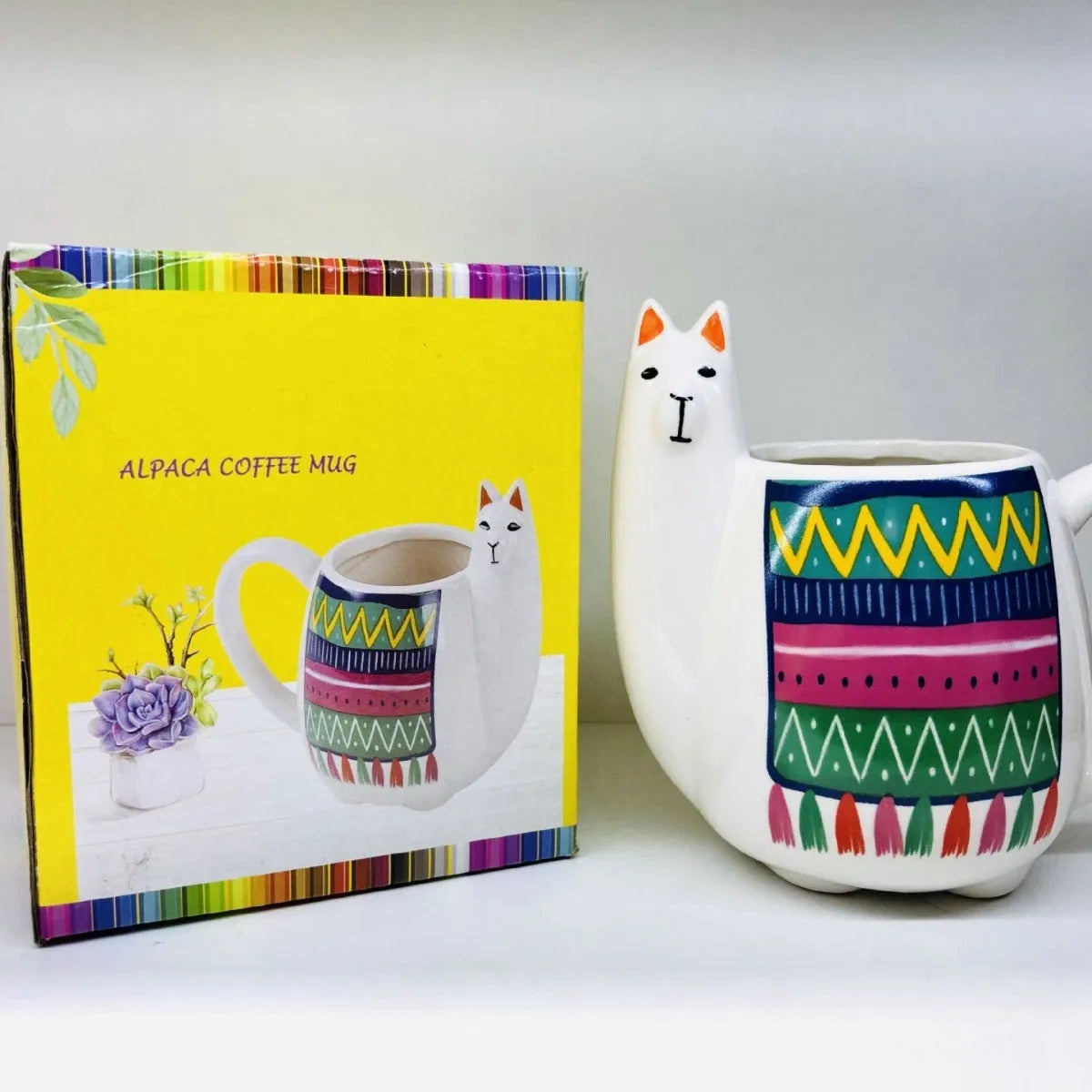 Colourful cartoon alpaca design on a white ceramic mug with a handle.
