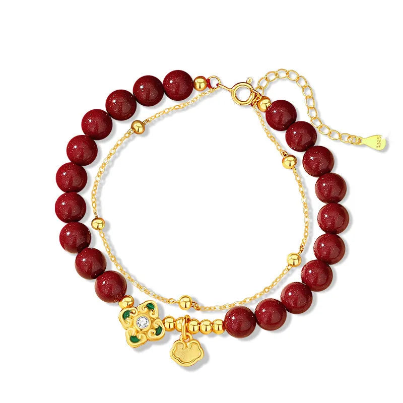 Women's geometric sterling silver bracelet with Ruyi, Xiangyun and red cinnabar flower detailing.