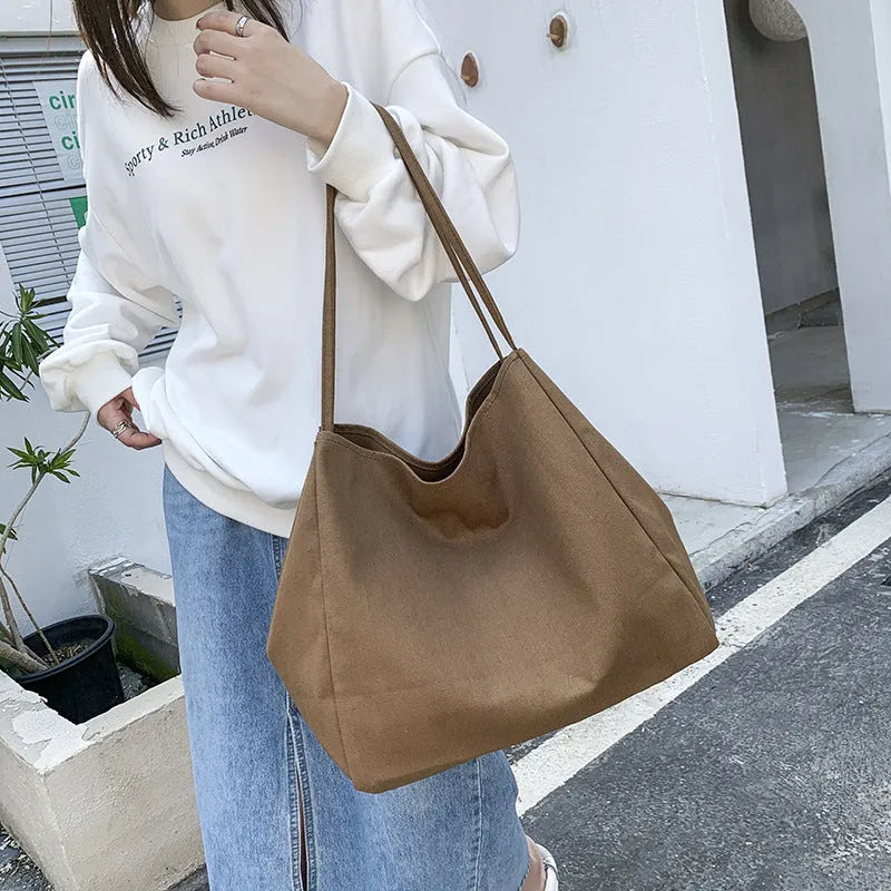 Solid colour women's canvas handbag with double shoulder straps and large capacity design