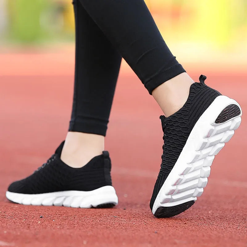 Women's running shoes with fly weaving upper in black, pink, or white, showing wear-resistant outsole