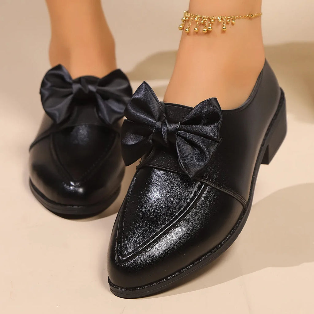 Women's British-style simple leather shoes with bow detailing, PU upper, and rubber sole in available sizes.