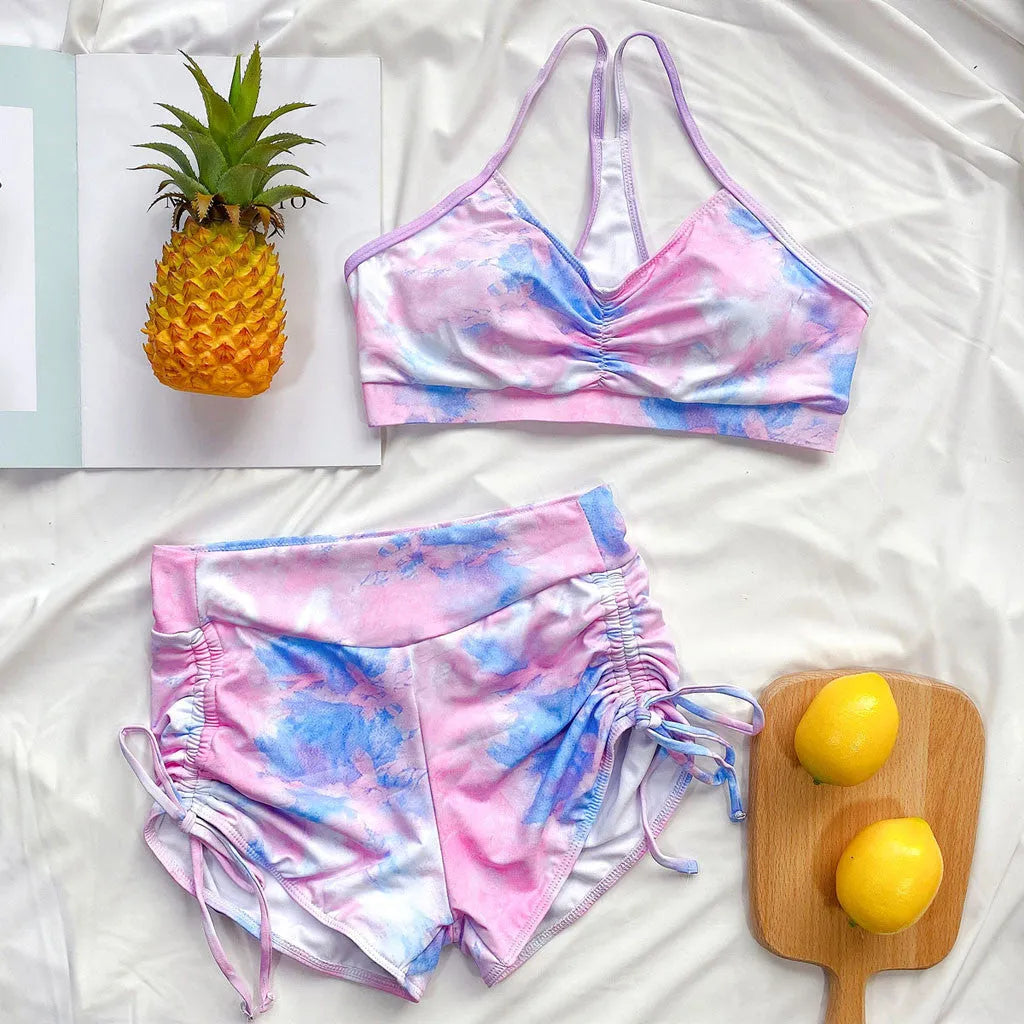 Tie-dye bikini shorts suit with push-up Brazilian top, nylon outer, polyester lining, light green or purple, sizes S to L.