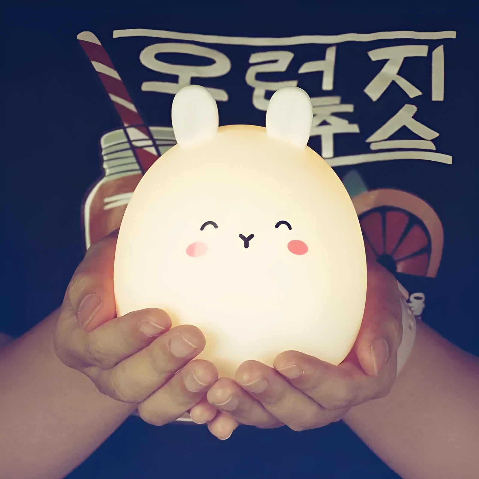 Silicone cute rabbit-shaped rechargeable night light showing colour change options and compact size.