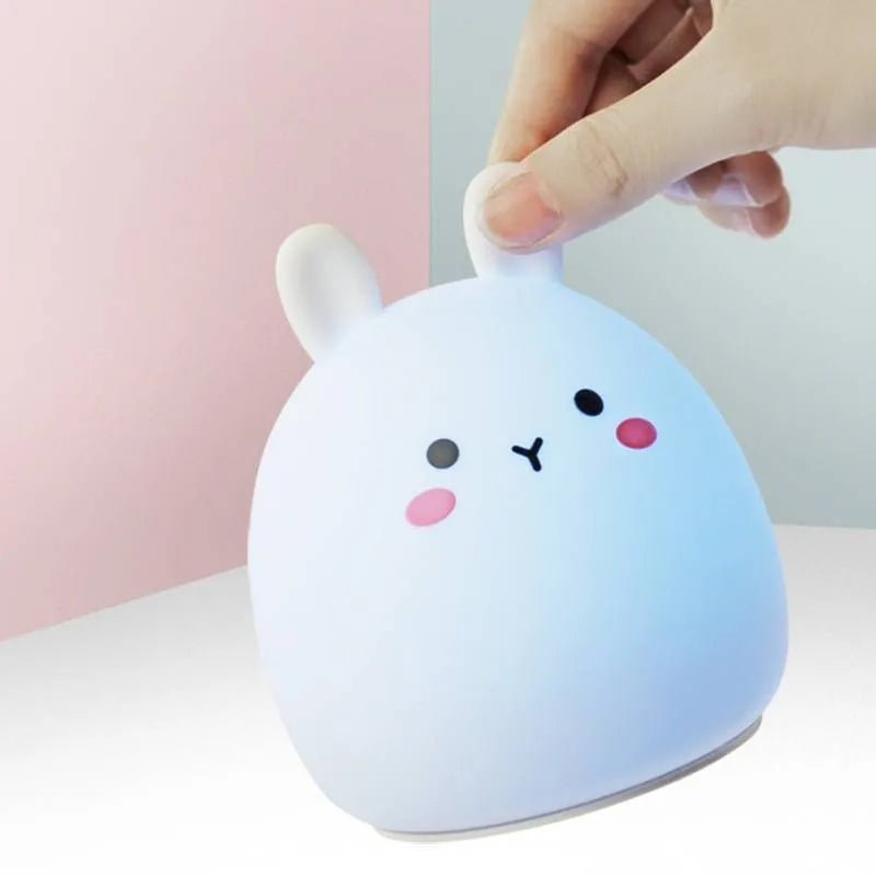 Silicone cute rabbit-shaped rechargeable night light showing colour change options and compact size.