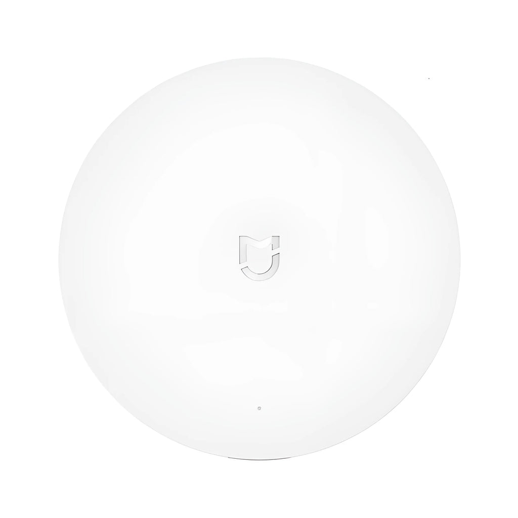 White circular smart home gateway with UK plug for wireless device control