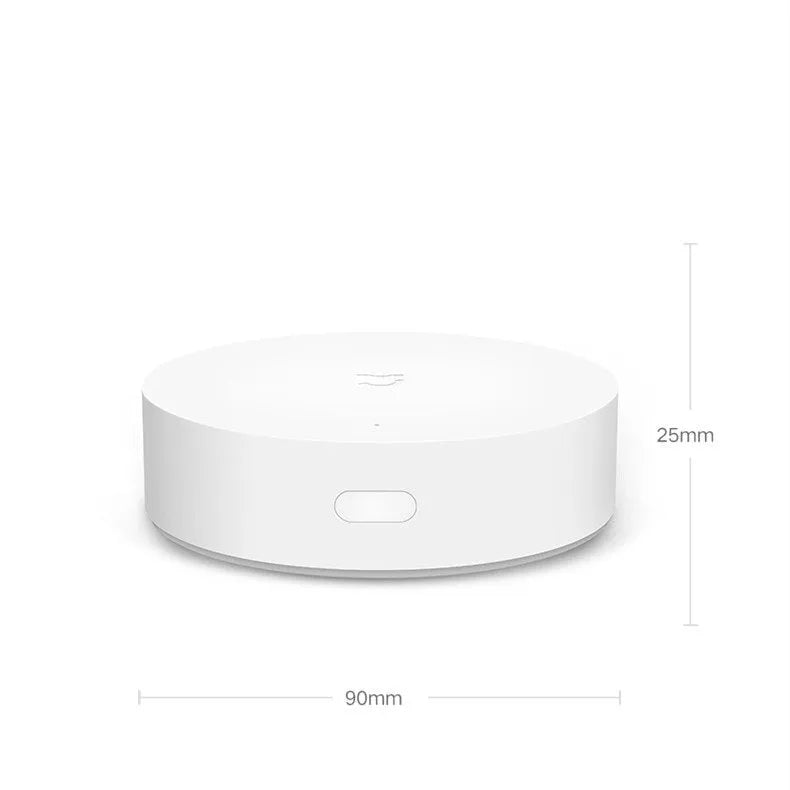 White circular smart home gateway with UK plug for wireless device control