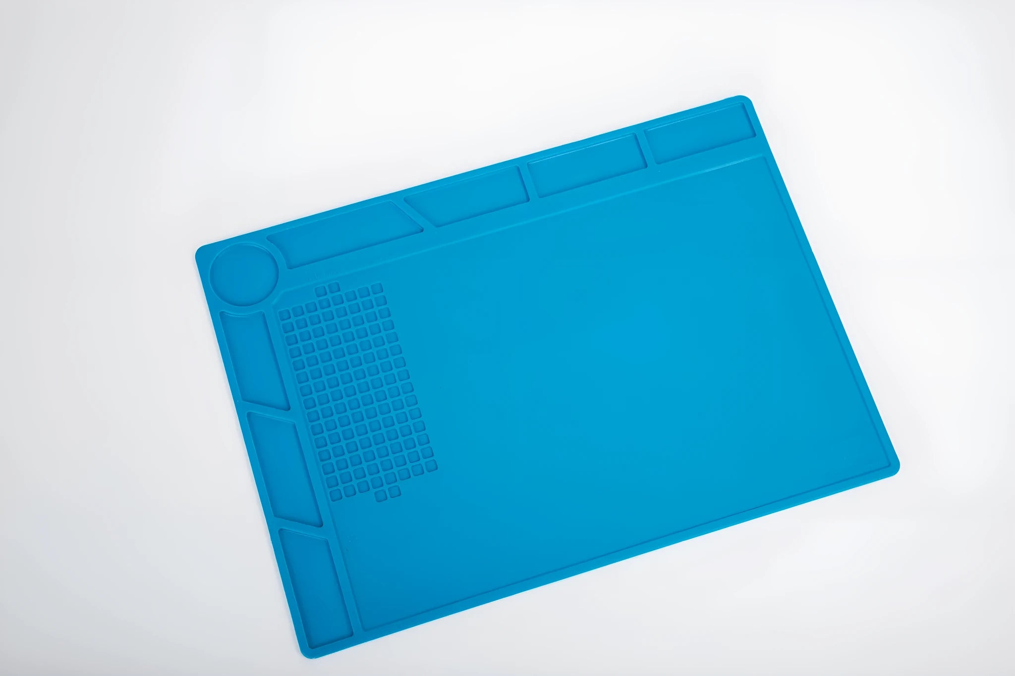 Blue silicone watch repair mat for anti-slip protection on work desks