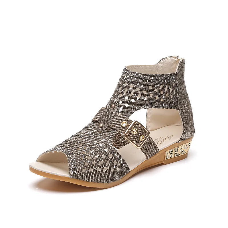 Women's beige rivet flat sandals with back zipper, low wedge heel, and fish mouth toe shape on a light background.