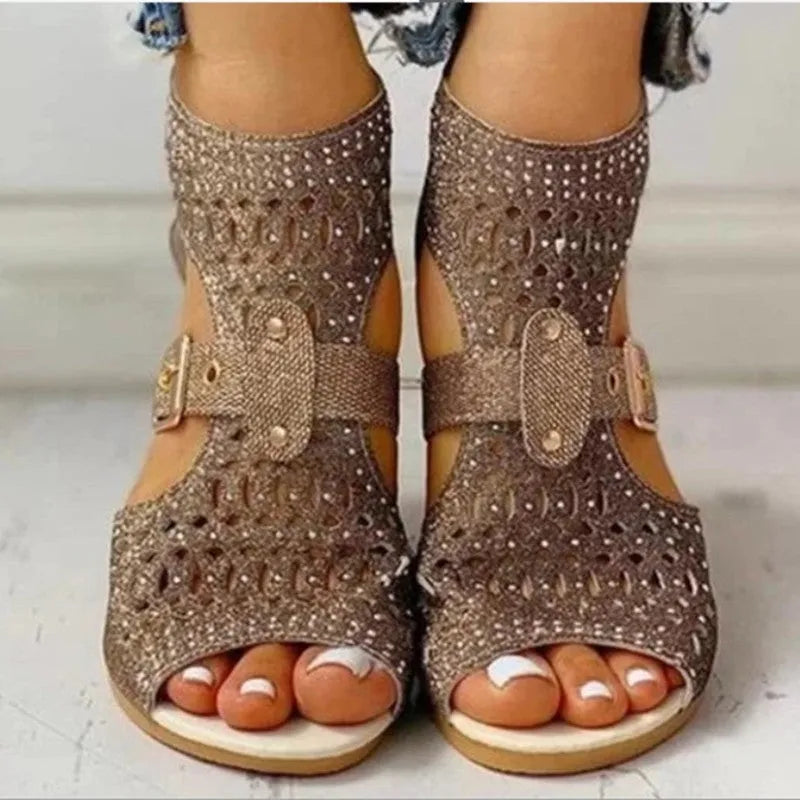 Women's flat sandals with back zipper, wedge heel, and fish mouth toe in beige, black, or gold colours.