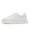 Women's mid-top platform sneakers with suede upper, thick sole, and lace-up design in black and white colours.