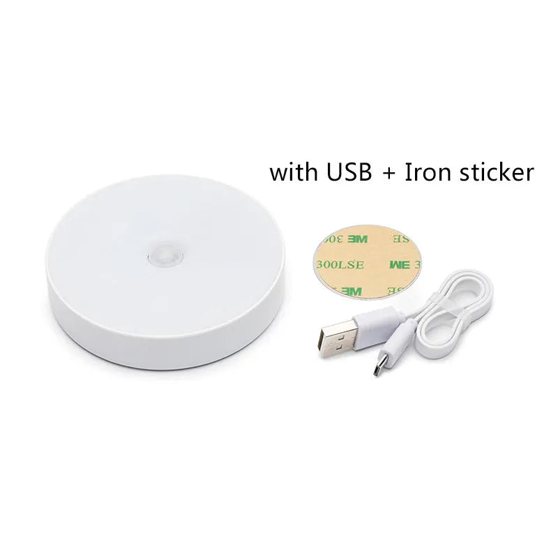 White circular LED motion night light with USB charging port, 86mm diameter, mounted with adhesive tape