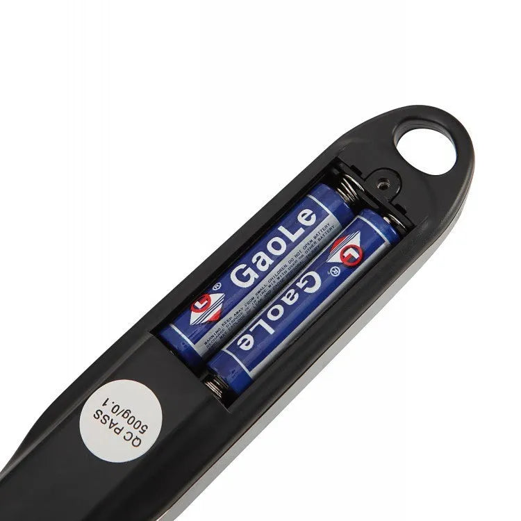 Digital measuring spoon with LCD display showing weight measurement