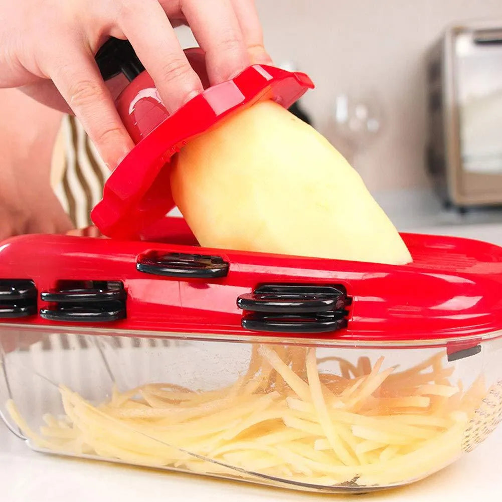 Red multi-function vegetable cutter with seven stainless steel blades and hand guard for safe slicing and dicing