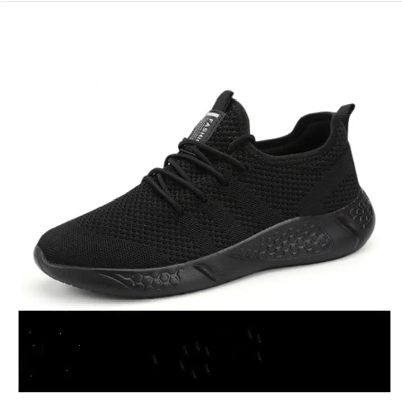 Men's black and white mesh sneakers with round toe design and lace-up closure on neutral background