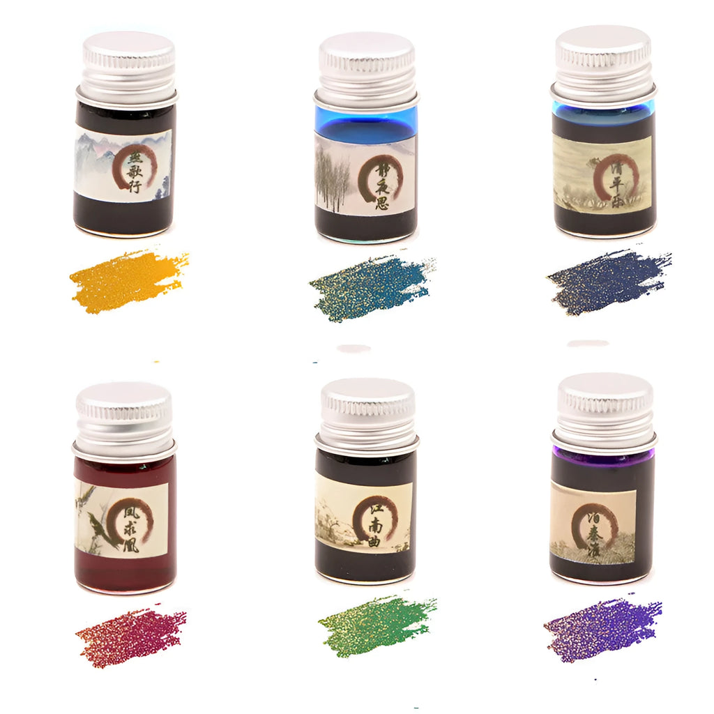 Set of six small high white glass bottles of gold powder antiquing ink for calligraphy in assorted colours