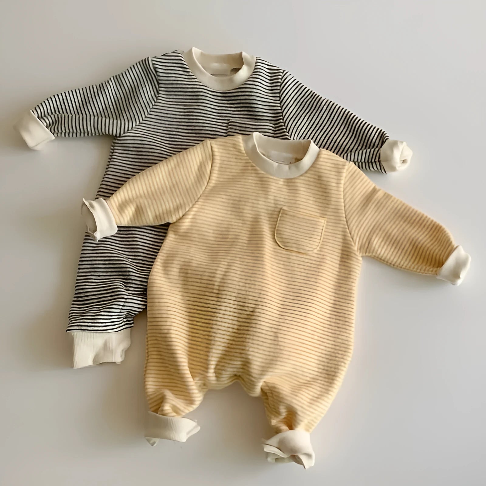 Striped cotton fleece baby jumpsuit with long sleeves and hidden buttons, shown in yellow and black.