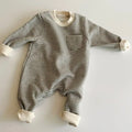 Striped cotton fleece baby jumpsuit with long sleeves and hidden buttons, shown in yellow and black.