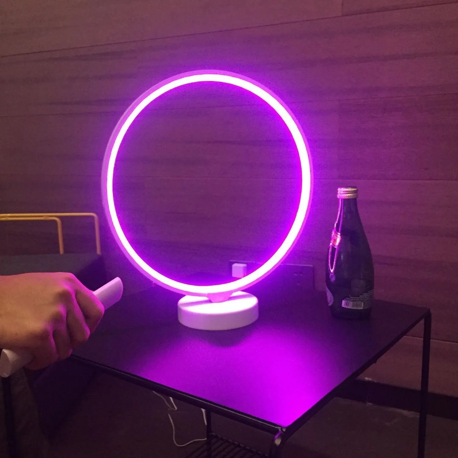 White Full Moon shaped table lamp with remote control on a wooden surface.