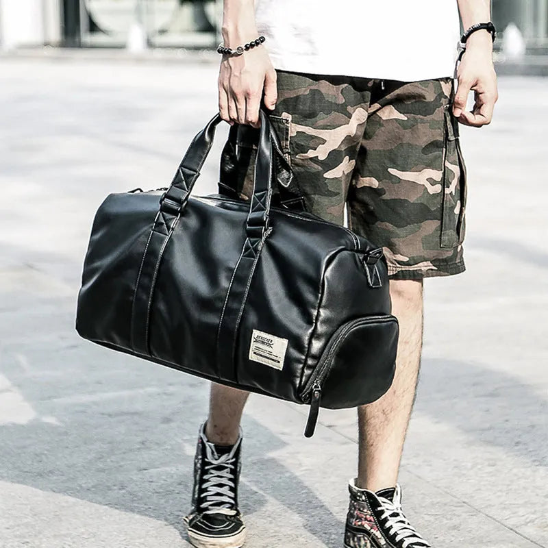 Large black PU leather sports training bag with multiple internal pockets, showing zipper opening and carry handle.