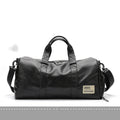 Large black PU leather sports training bag with multiple internal pockets, showing zipper opening and carry handle.