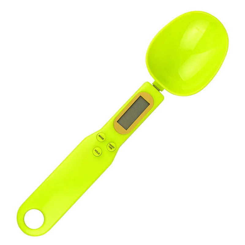 Black electronic measuring spoon scale showing digital display with 0.1g precision for kitchen weighing