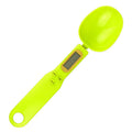 Black electronic measuring spoon scale showing digital display with 0.1g precision for kitchen weighing