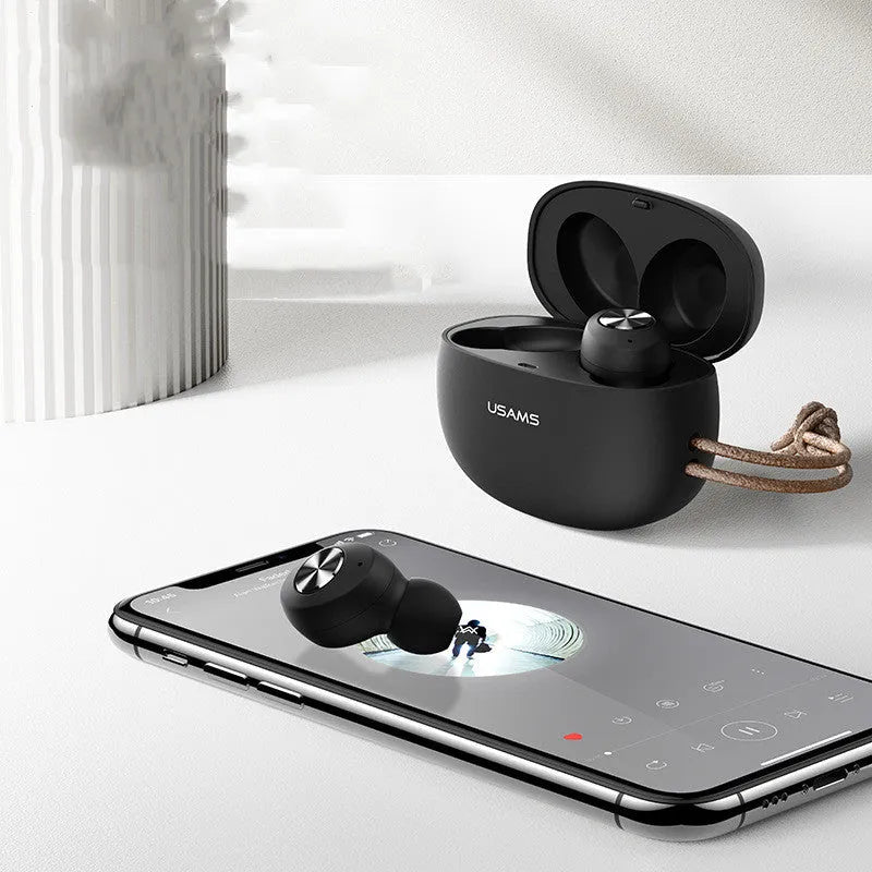 Wireless Bluetooth Mini TWS Binaural Headphones Pebble Series in black, showing earbuds and charging compartment