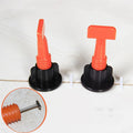 Pack of 50 white PE plastic tile positioning regulators and a metal wrench for levelling wall tiles.