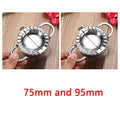 Stainless steel dumpling mould and rectangular dough cutter on a kitchen surface.