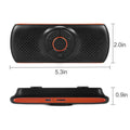 Orange Bluetooth car hands-free speaker mounted on vehicle sun visor