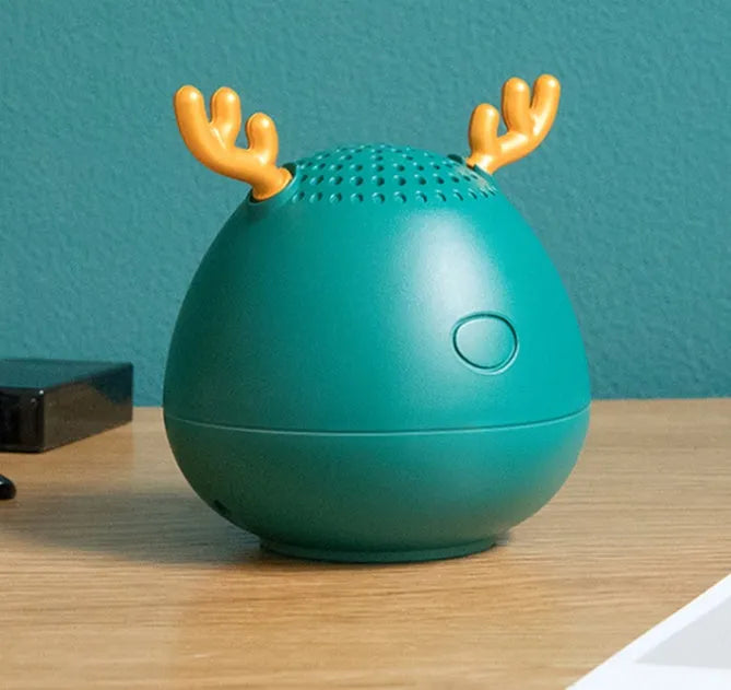 Compact portable Bluetooth speaker in green, pink or white with USB charging cable