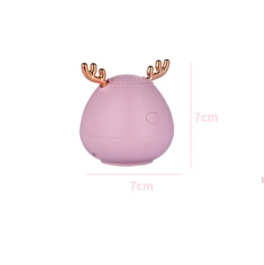 Compact portable Bluetooth speaker in green, pink or white with USB charging cable